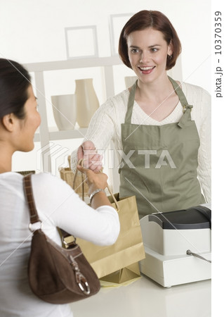 Shopkeeper with customer Shopkeeper with customer 10370359