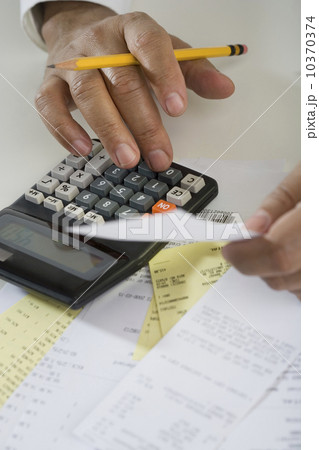 Close up of man using calculator 10370374