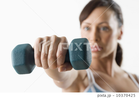 Woman holding hand weight Woman holding hand weight 10370425