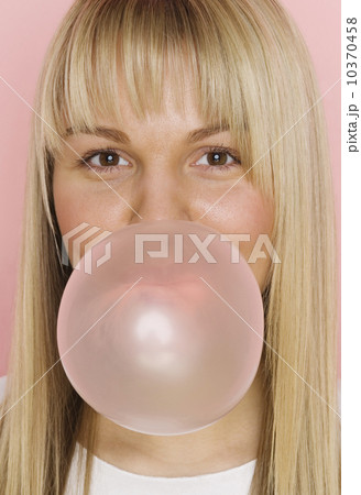 Close up of woman blowing bubble with bubble gum Close up of woman blowing bubble with bubble gum 10370458
