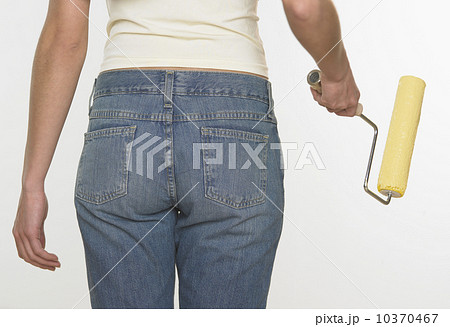 Rear view of woman holding paint roller Rear view of woman holding paint roller 10370467