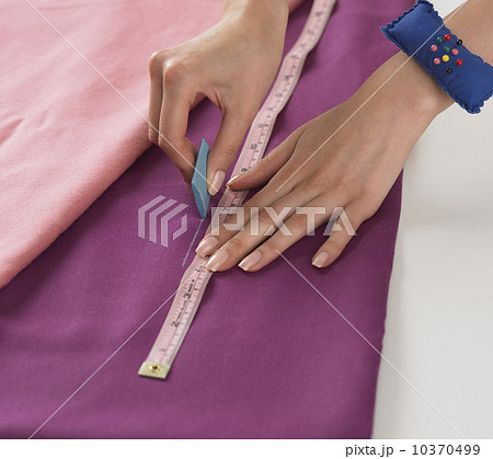 Close up of woman cutting fabric 10370499