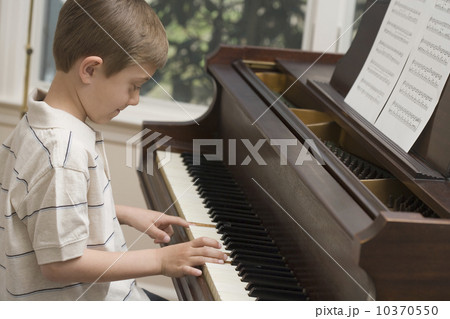 Young boy playing piano Young boy playing piano 10370550
