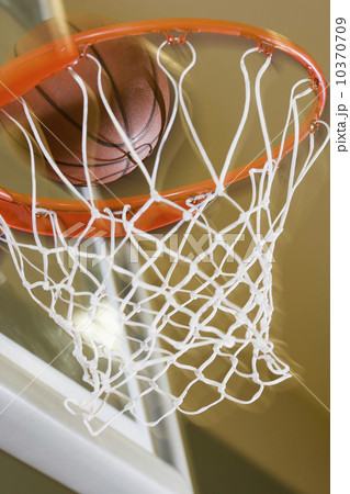 Close up of basketball entering hoop Close up of basketball entering hoop 10370709