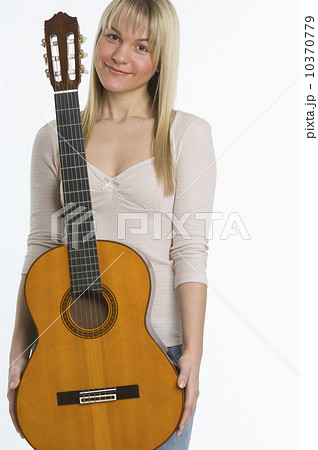 Studio shot of woman with guitar Studio shot of woman with guitar 10370779