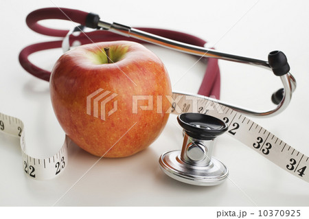 Close up of apple, tape measure and stethoscope Close up of apple, tape measure and stethoscope 10370925
