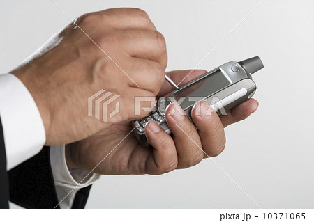 Close up of man using PDA 10371065