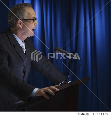 Close up of businessman speaking at podium Close up of businessman speaking at podium 10371129