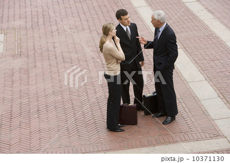 Three business people talking outdoors 10371130