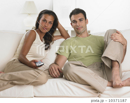 Couple sitting on sofa watching television 10371187
