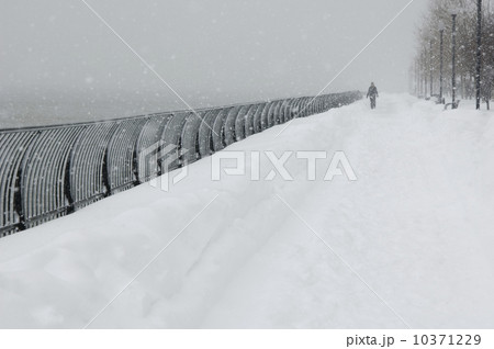 Person walking outdoors in a snowstorm 10371229