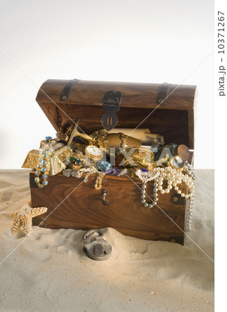 Wooden chest overflowing with treasure 10371267