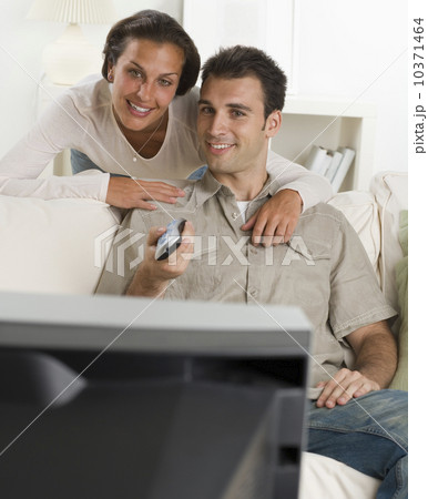 Couple on sofa watching television Couple on sofa watching television 10371464