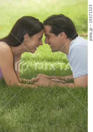 Couple touching foreheads and smiling in grass 10371523