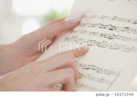Close up of woman pointing at sheet music 10371540