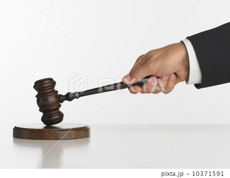 Close up studio shot of judge's hand with gavel Close up studio shot of judge's hand with gavel 10371591