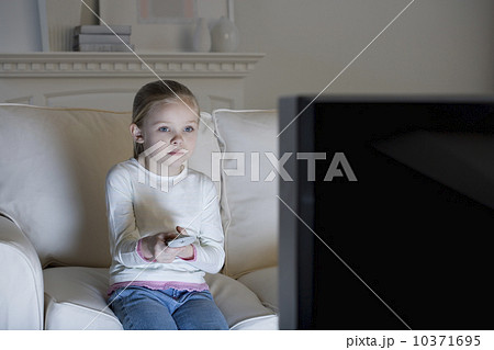 Young girl watching television Young girl watching television 10371695