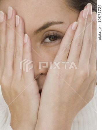 Close up of woman covering face with hands Close up of woman covering face with hands 10371726