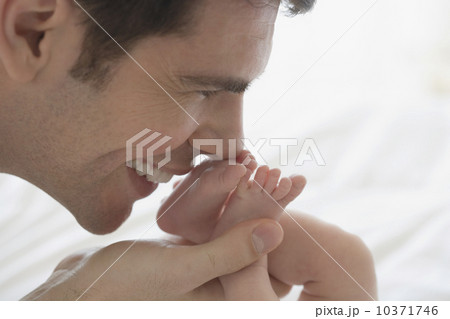 Father kissing newborn baby's feet 10371746