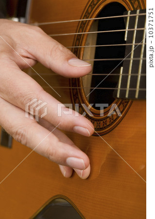 Close up of man's hand playing guitar Close up of man's hand playing guitar 10371751