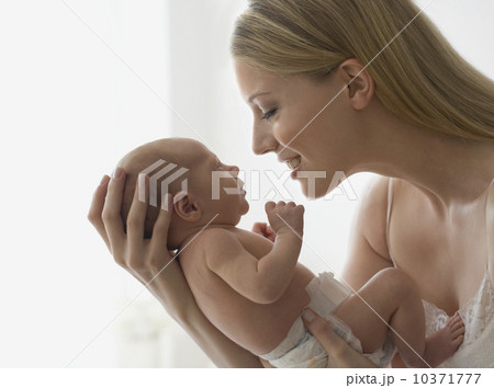 Mother smiling at newborn baby 10371777
