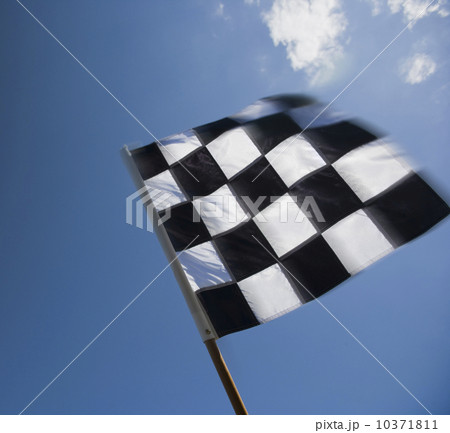 Checkered flag waving under blue sky Checkered flag waving under blue sky 10371811