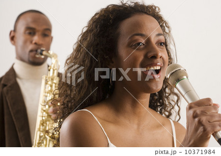 Woman singing into microphone 10371984