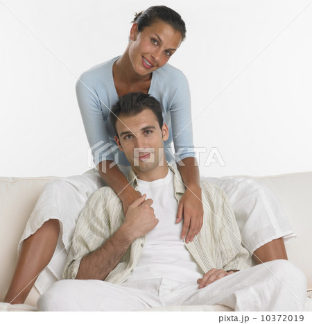 Couple smiling on sofa 10372019