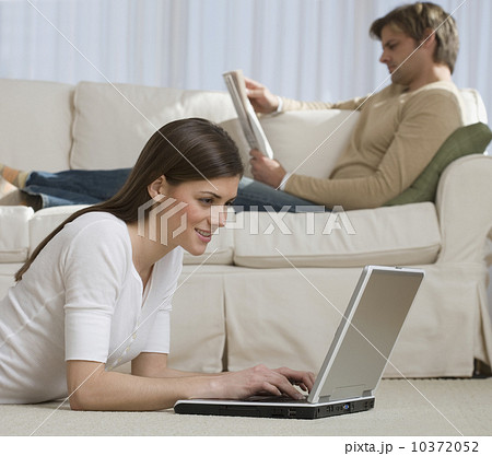 Couple relaxing in livingroom Couple relaxing in livingroom 10372052