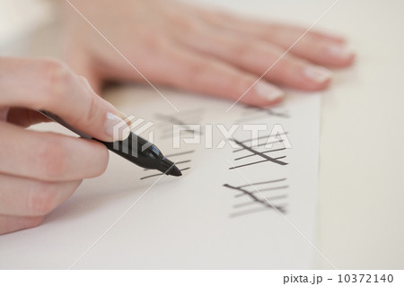 Close up of woman counting on paper Close up of woman counting on paper 10372140