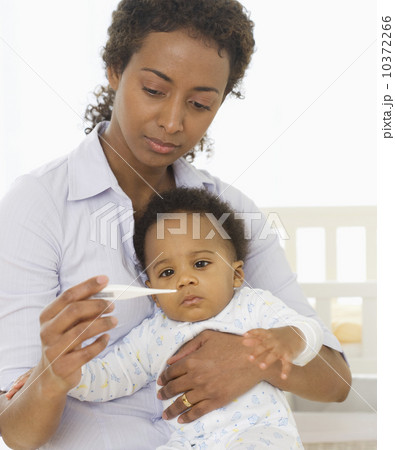 Mother taking baby’s temperature Mother taking baby’s temperature 10372266