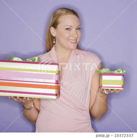 Woman holding big and small gifts Woman holding big and small gifts 10372337
