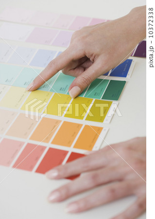 Close up of woman comparing paint swatches 10372338