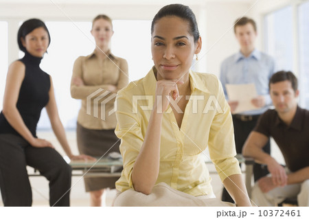 Portrait of businesswoman with coworkers in background 10372461