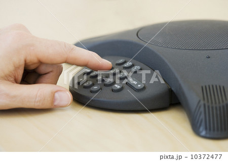 Businessman dialing conference call 10372477