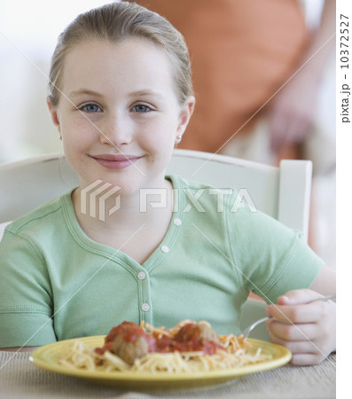 Girl eating spaghetti and meatballs Girl eating spaghetti and meatballs 10372527