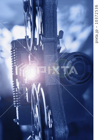 Old fashioned movie projector playing film 10372536