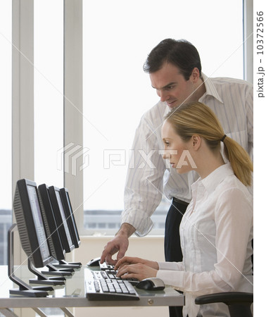 Businesspeople looking at computer Businesspeople looking at computer 10372566