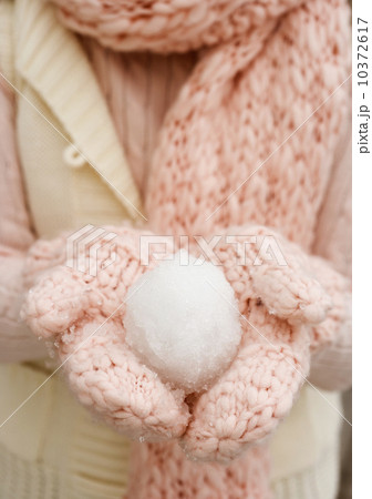 Person holding snowball in gloved hands Person holding snowball in gloved hands 10372617