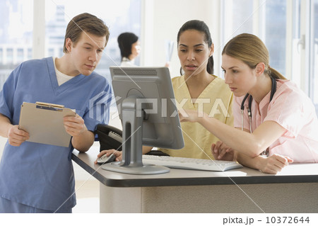 Doctors looking at computer in hospital Doctors looking at computer in hospital 10372644