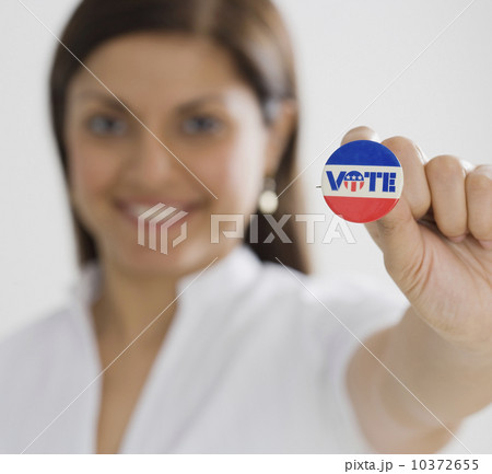 Indian woman holding up Vote pin 10372655