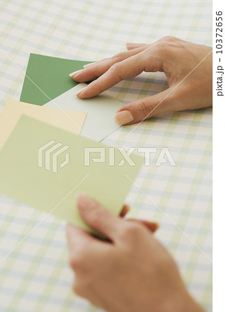 Close up of woman comparing paint swatches Close up of woman comparing paint swatches 10372656