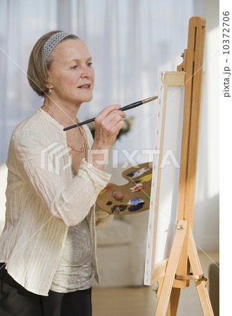 Senior woman painting on easel Senior woman painting on easel 10372706