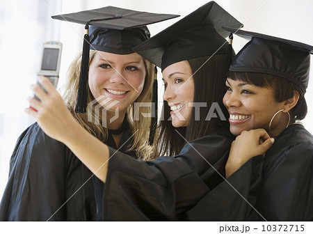Multi-ethnic female graduates taking own photograph 10372715
