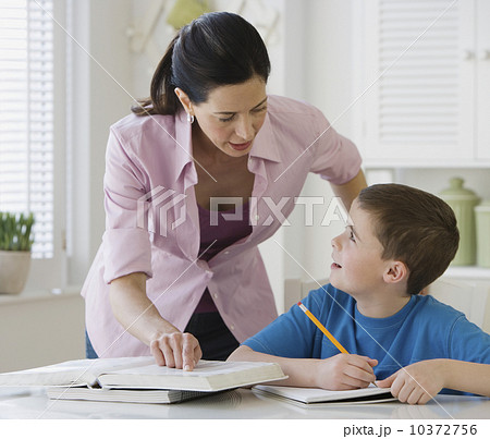 Mother helping son with homework Mother helping son with homework 10372756