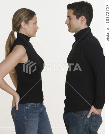 Studio shot of couple with hands in back pockets 10372757