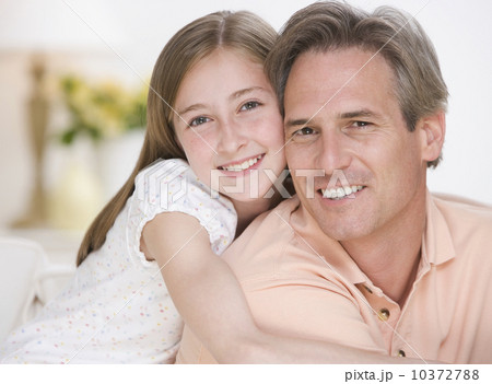 Close up of daughter hugging father 10372788