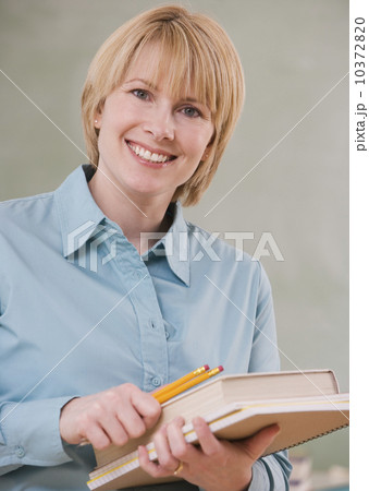 Woman holding school books and pencils 10372820