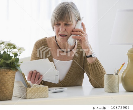Senior woman looking at bills 10372905