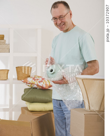 Man unpacking moving boxes 10372907